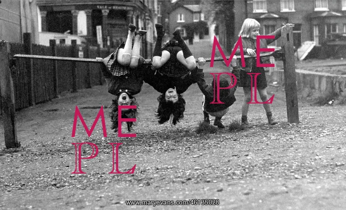: Four children doing acrobatics on a railing : Four children doing acrobatics on a railing
