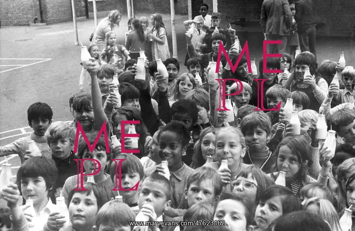 : Children drinking milk in a playground, Woolwich, London : Children drinking milk in a playground, Woolwich, London