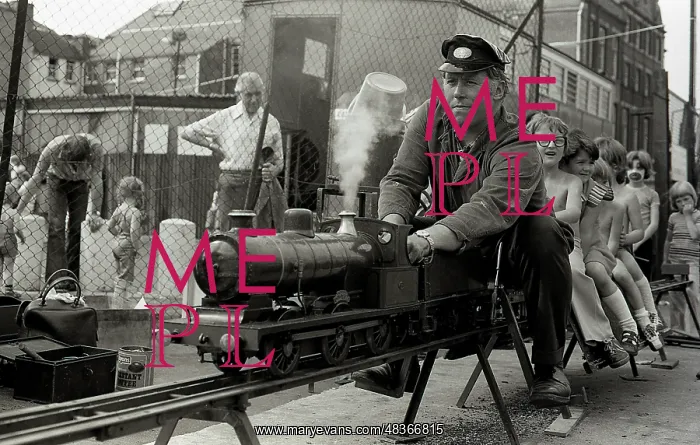 : Children enjoy a ride on a model steam train : Children enjoy a ride on a model steam train
