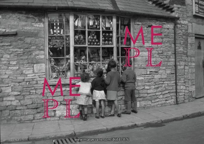 : Four children gazing through shop window : Four children gazing through shop window