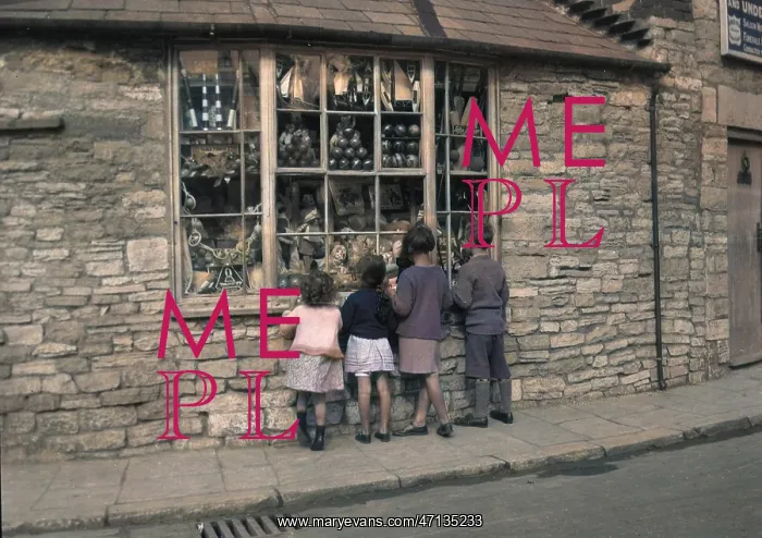 : Four children gazing through shop window : Four children gazing through shop window