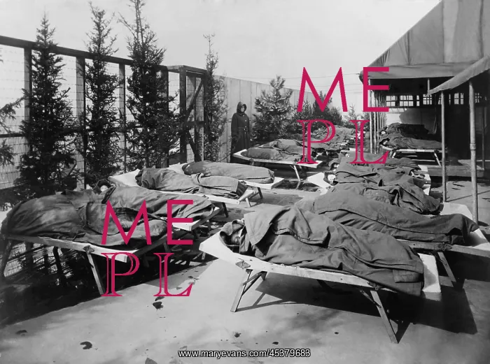  : Children lie on cots, wrapped in blankets