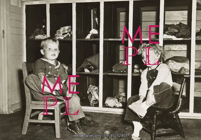 : Children take off their shoes before a nap in : Children take off their shoes before a nap in