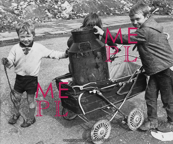 : Children playing with milk churn and pram : Children playing with milk churn and pram