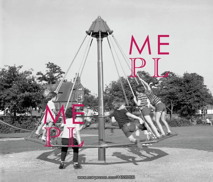 : Children playing on an umbrella roundabout : Children playing on an umbrella roundabout