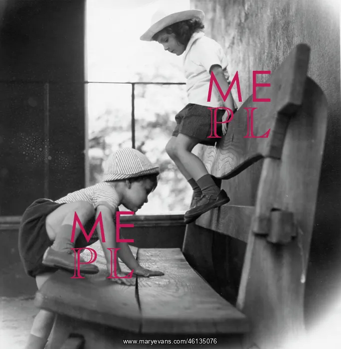 : Two children playing on a wooden bench : Two children playing on a wooden bench