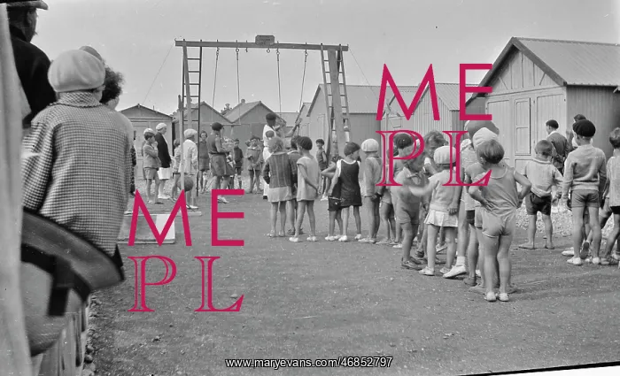 : Children queueing up for a ride on the swings : Children queueing up for a ride on the swings