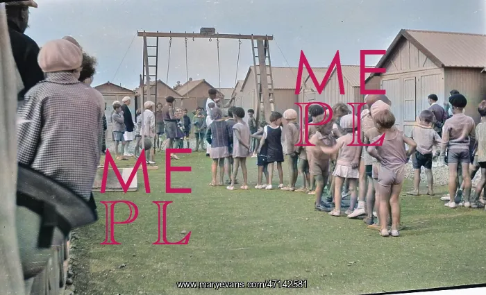 : Children queueing up for a ride on the swings : Children queueing up for a ride on the swings