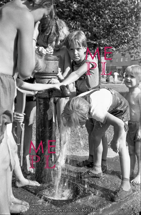 : Children refresh themselves at drinking fountain : Children refresh themselves at drinking fountain