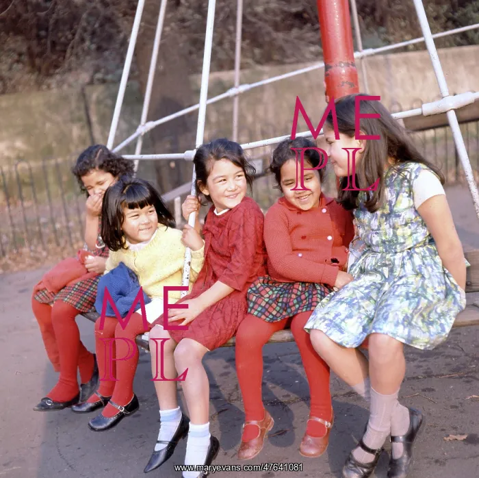  : Five children on a roundabout in a park