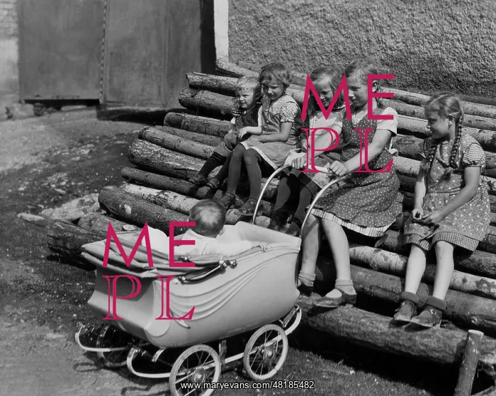  : Children on a stack of logs, 1937