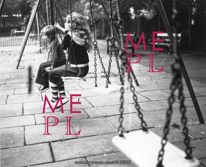 : Two children on swings in a playground : Two children on swings in a playground