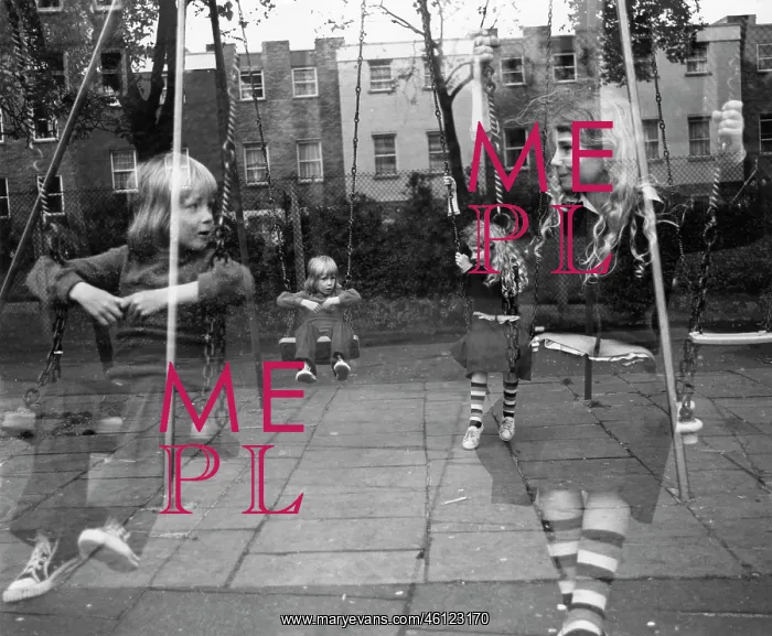 : Two children on swings in a playground : Two children on swings in a playground