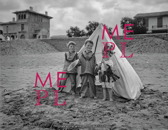 : Three children with tent on a beach : Three children with tent on a beach