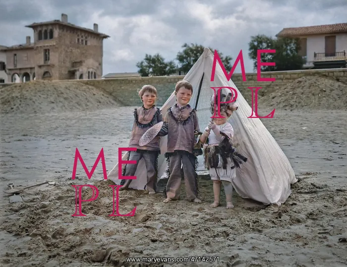 : Three children with tent on a beach : Three children with tent on a beach