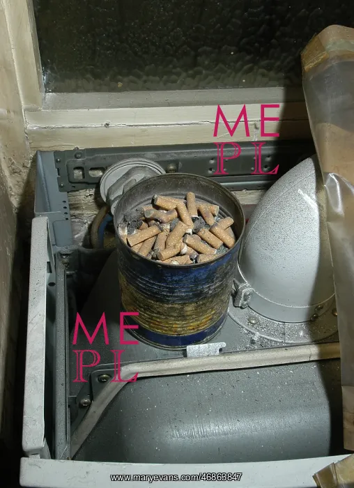  : Cigarette butts in a tin