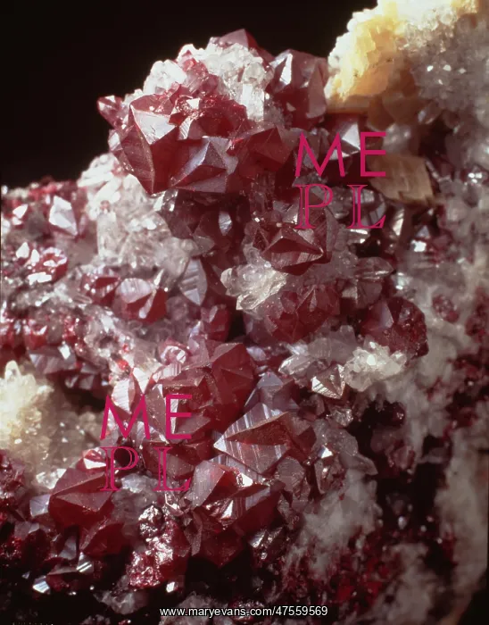 : Cinnabar. Twinned dark red cinnabar crystals with small quartz crystals : Cinnabar. Twinned dark red cinnabar crystals with small quartz crystals