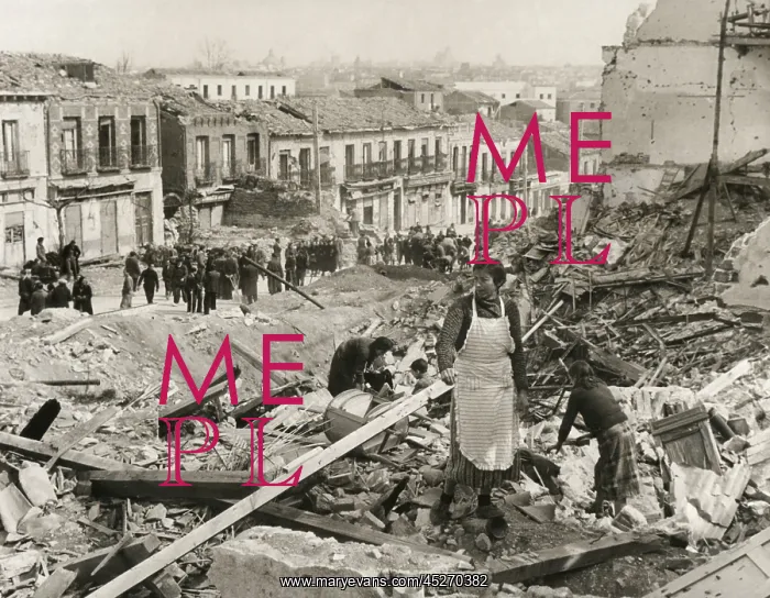 : Civilians in Madrid search through the rubble : Civilians in Madrid search through the rubble