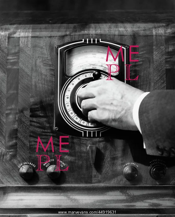  : Close up man's hand turning radio dial