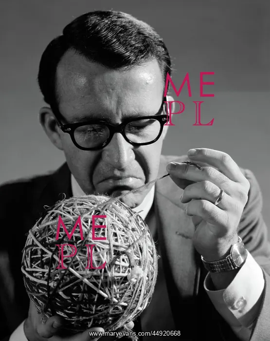 : Close-up of man in suit & glasses pulling strand : Close-up of man in suit & glasses pulling strand