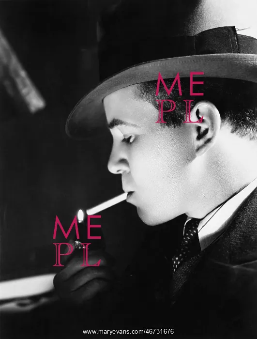 : Close-up of a young man with a hat lighting a cigarette : Close-up of a young man with a hat lighting a cigarette