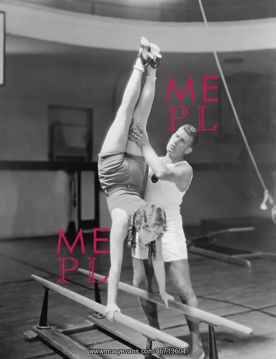 : Coach helping woman on parallel bars : Coach helping woman on parallel bars