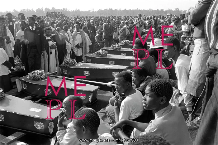 : Coffins lined up at gravesites at a mass funeral held : Coffins lined up at gravesites at a mass funeral held