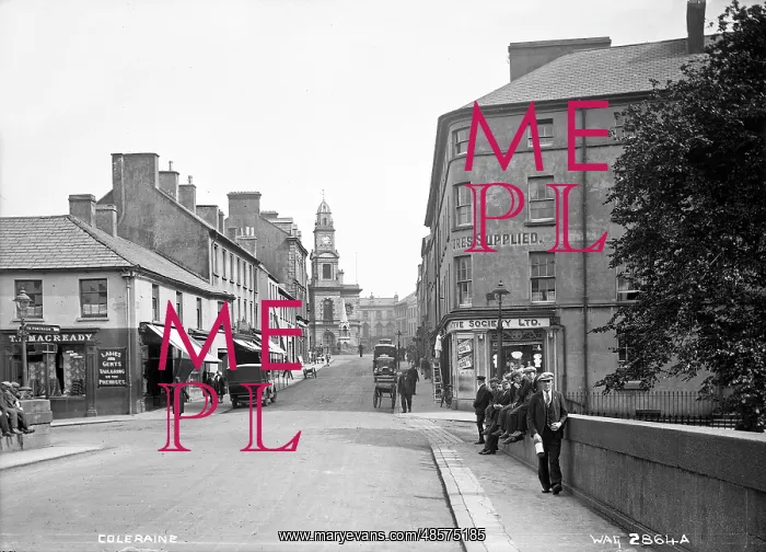 : Coleraine - a street scene with shop fronts, motor cars and people, taken : Coleraine - a street scene with shop fronts, motor cars and people, taken