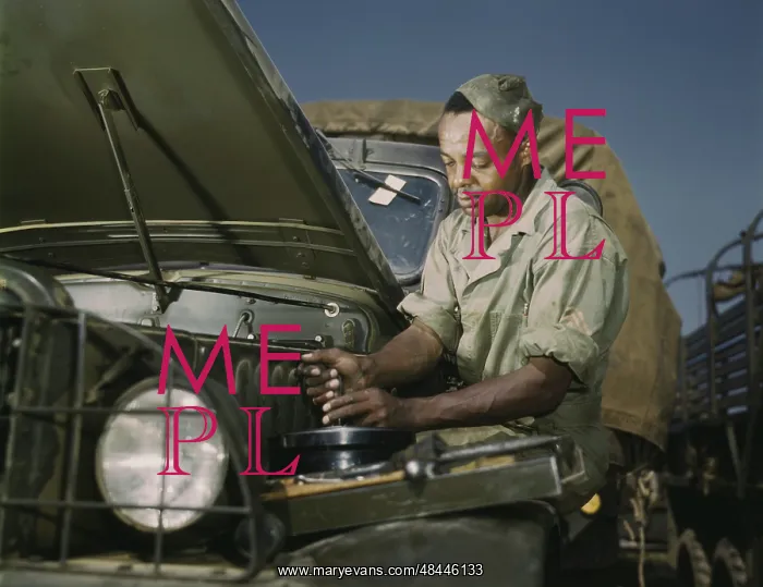 : A colored mechanic doing maintenance on Army trucks, 1941 : A colored mechanic doing maintenance on Army trucks, 1941