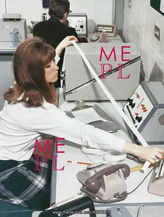 : A computer technician with data tape : A computer technician with data tape