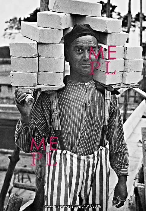 : A concentration camp internee carrying bricks for constructi : A concentration camp internee carrying bricks for constructi