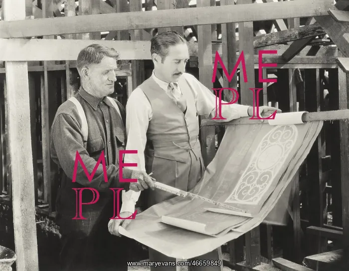 : Construction worker going over plans with architect : Construction worker going over plans with architect