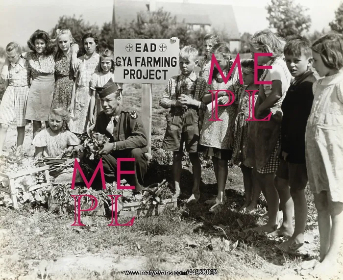 : A Corporal with German Children Growing Vegetables at th? : A Corporal with German Children Growing Vegetables at th?