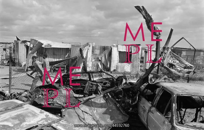 : Corrugated iron shacks and vehicles gutted by fire : Corrugated iron shacks and vehicles gutted by fire