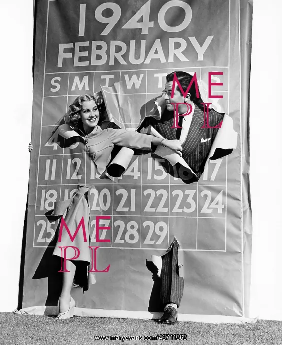 : Couple bursting through leap year calendar : Couple bursting through leap year calendar
