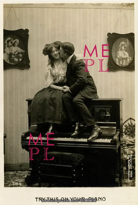 : Couple canoodling on a piano : Couple canoodling on a piano
