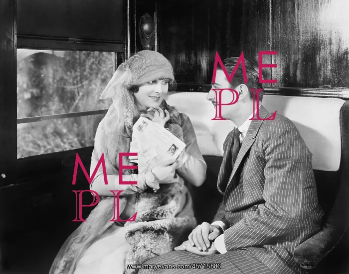 : Couple in a compartment of a train looking and talking : Couple in a compartment of a train looking and talking