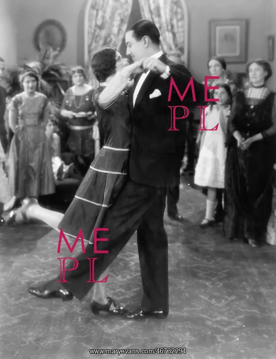 : Couple dancing lightly while others are watching : Couple dancing lightly while others are watching