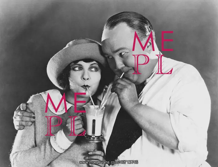 : Couple drinking beverage with straw