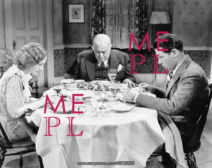 : Couple with their father sitting at the dining table : Couple with their father sitting at the dining table