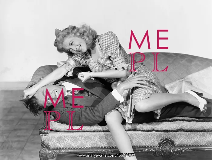 : Couple having a playful fight on a couch : Couple having a playful fight on a couch