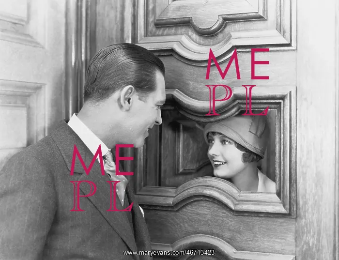 : Couple interacting through hole in door : Couple interacting through hole in door