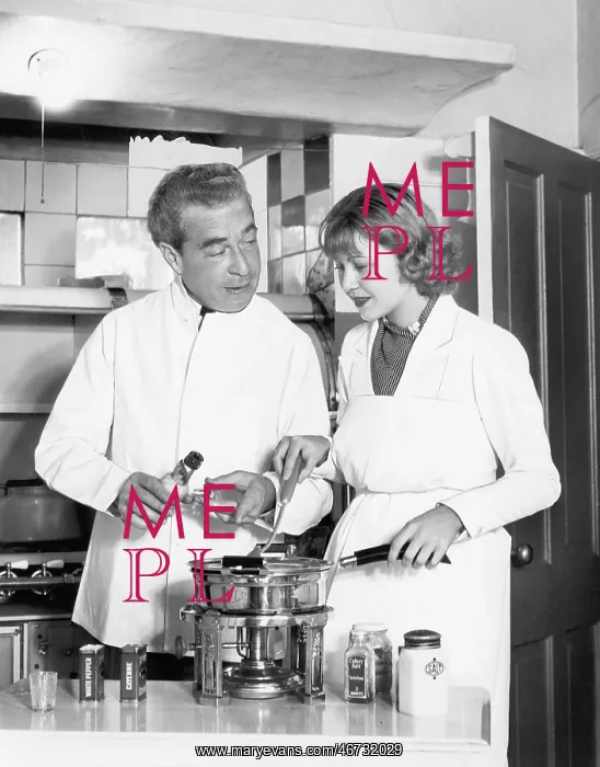 : Couple together in the kitchen preparing a fondue : Couple together in the kitchen preparing a fondue