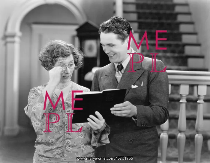 : Couple looking at a book together : Couple looking at a book together