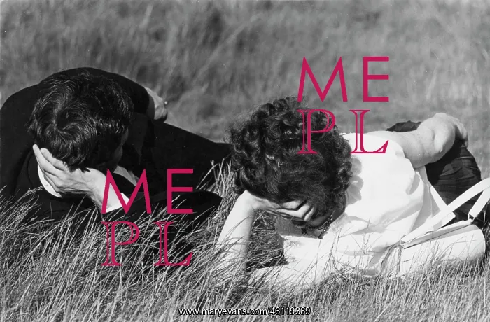 : Couple lying on the grass in a park : Couple lying on the grass in a park