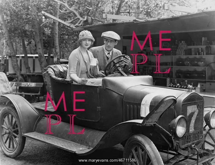 : Couple in an old veteran car : Couple in an old veteran car