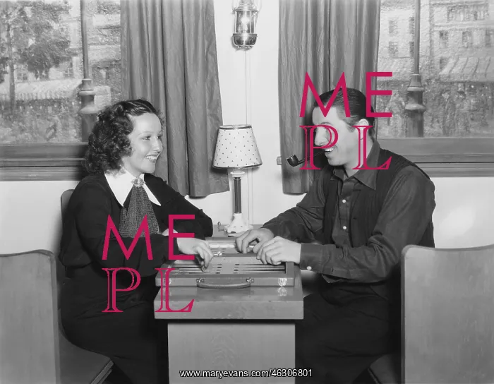: Couple playing backgammon : Couple playing backgammon