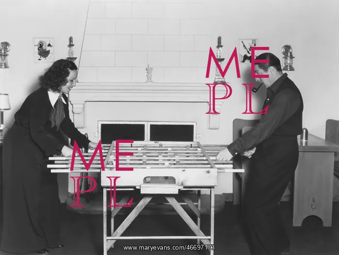  : Couple playing foosball