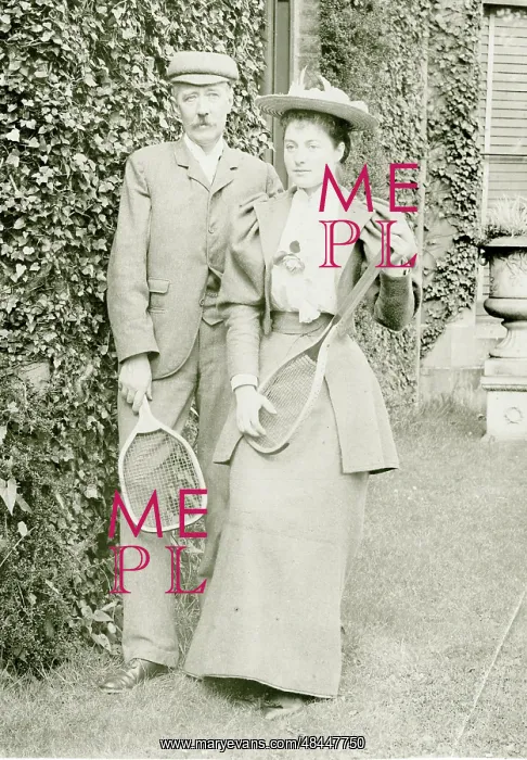  : Couple posing with tennis rackets