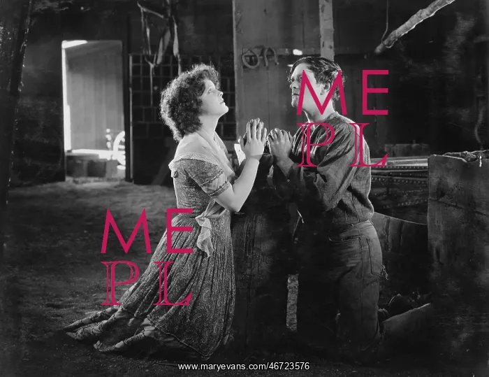 : Couple praying together in barn : Couple praying together in barn